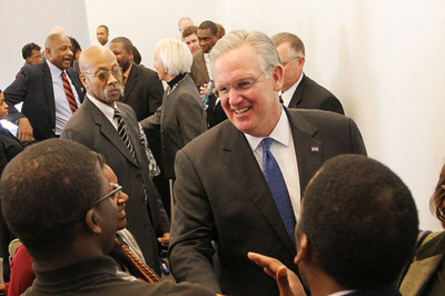 Mo. Gov. Jay Nixon shakes hands in Jan. with students after outlining his plan that would include low-income students in the A-plus Community College scholarship program. Nixon signed legislation today regarding education funding in Mo.