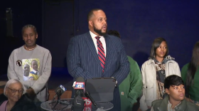 Members of Jazmir Tucker's family surround attorney Robert Gresham (center) as he speaks about the lawsuit the family filed against the city of Akron. 