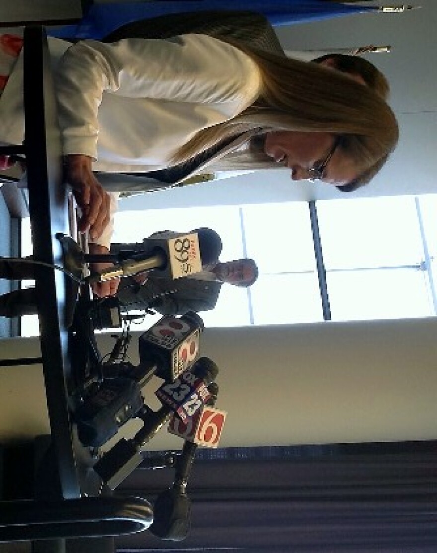 Councilor Karen Gilbert talks with reporters at today's news conference.