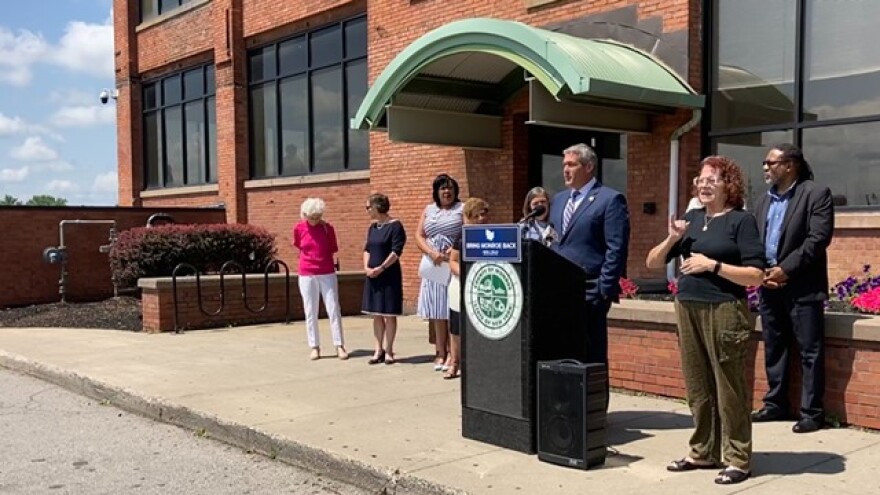 County Executive Adam Bello, standing outside of 691 St. Paul St., announced Wednesday that the county plans to offer more of its social services through smaller, community-based organizations.