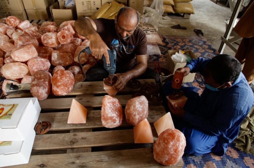 workers creating salt lamps