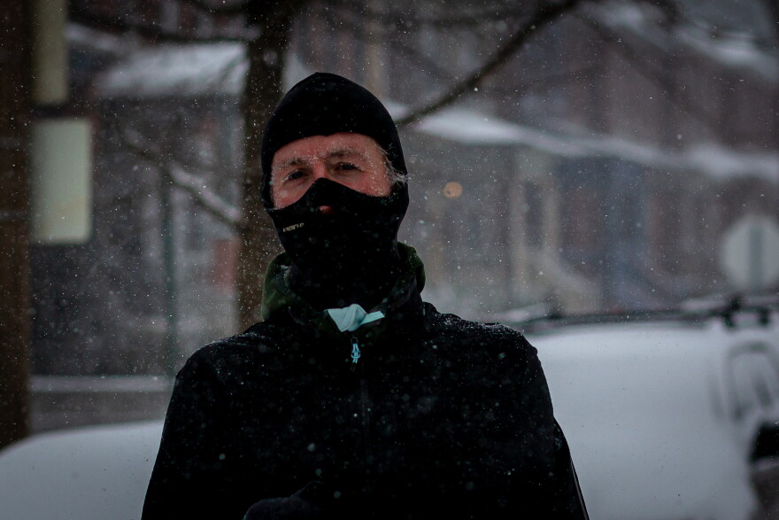 Bill Winfrey, 34, runs through the Tower Grove South neighborhood on Monday. He and his wife have a pact to run every day. And this day, when St. Louis is forecast to receive 4-7 inches of snow with temperatures not breaking the single digits, is his turn.