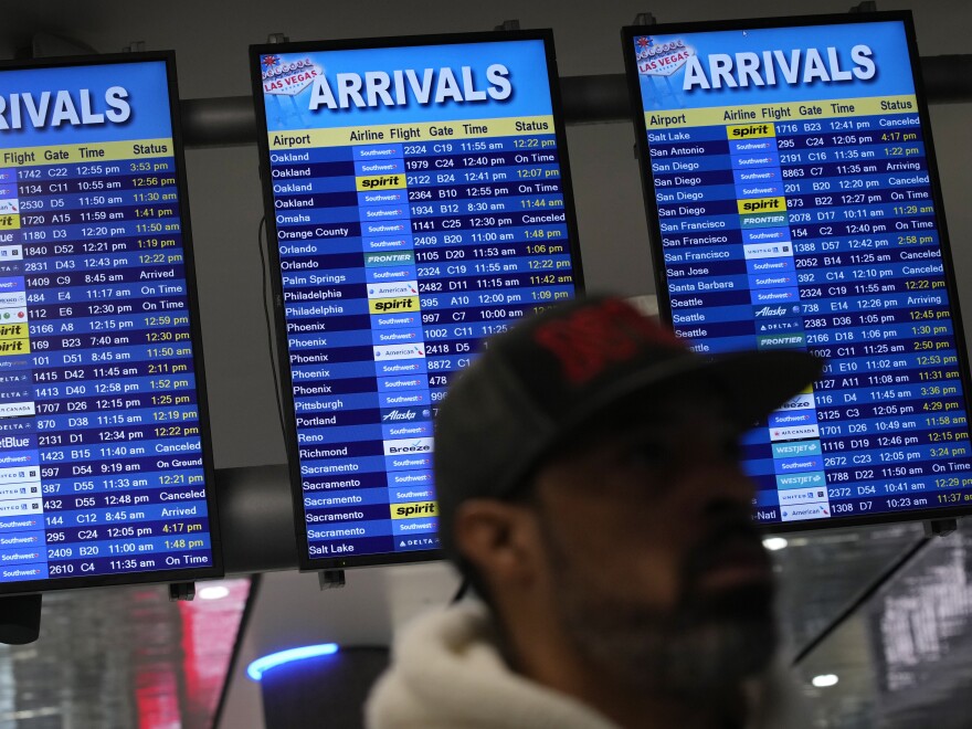 Flight status boards show delayed and canceled flights at Harry Reid International Airport in Las Vegas.