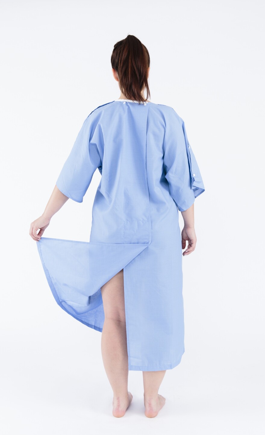 Instead of flimsy ties, the back of the new gown has a flap to cover the patient's behind.