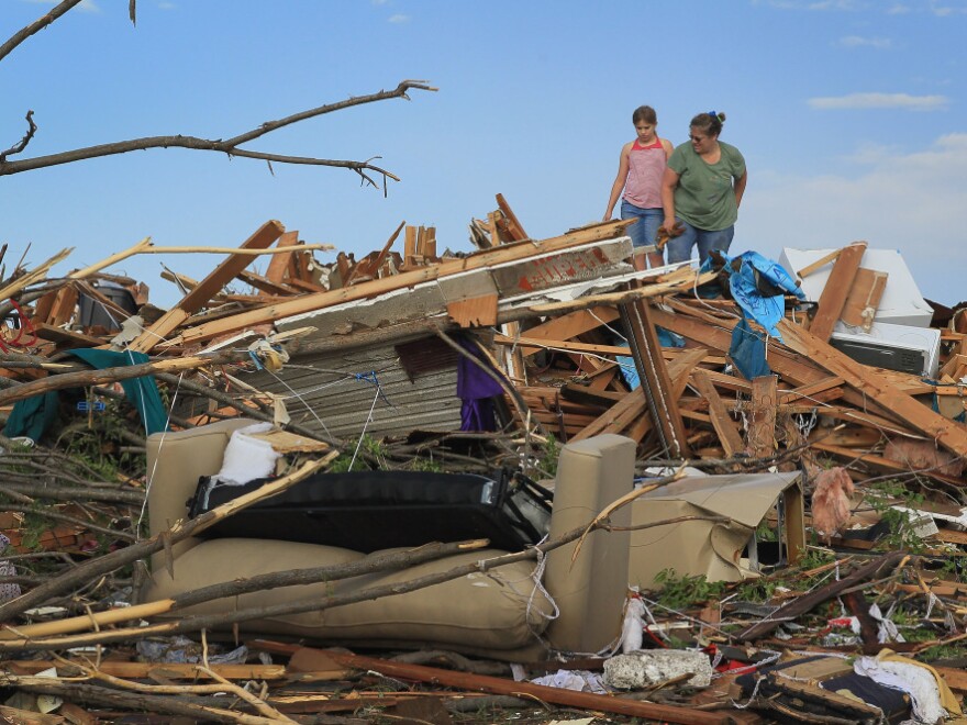 Nine-year-old Maddie Meek (L) and her mother Dina Meek salvaged what they could from a relative's home in Joplin earlier today (May 24, 2011).