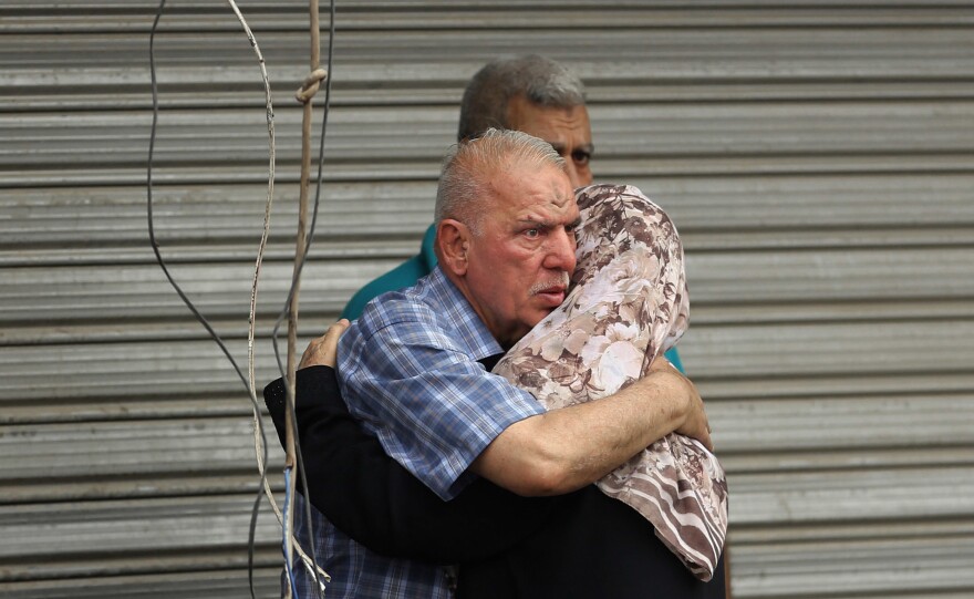 Iraqi family members whose relatives went missing after the bomb hit Karada.