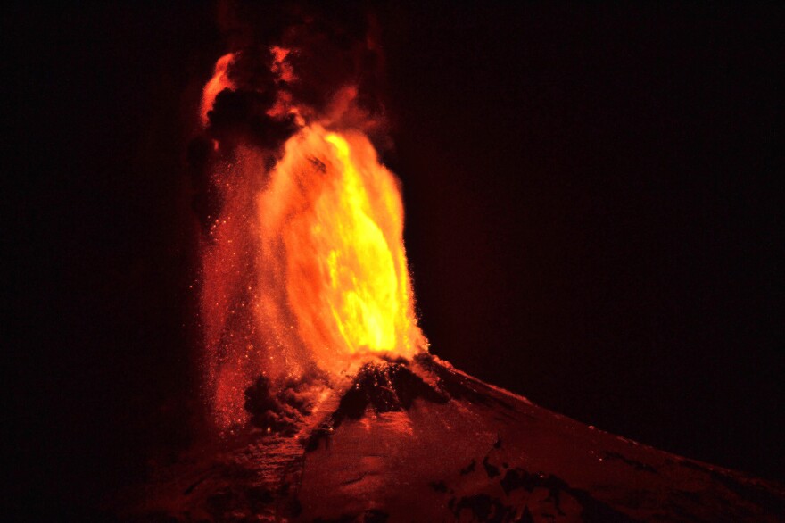 Ash and lava spew from the volcano, as seen from Pucon, Chile.
