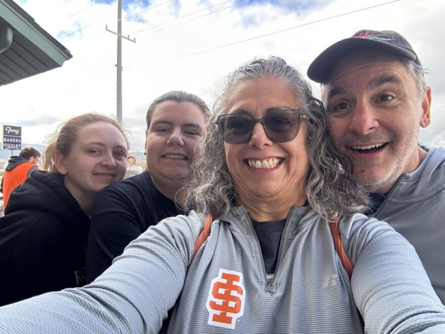 Four people smiling into a camera