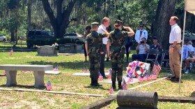 Members of the Milton Lewis Young Marines perform the flag folding ceremony at Evergreen Cemetery. They told of the significance of the 13 step process detailing the meaning to each of the folds.Milton Lewis' family members & members of the Milton Lewis Young Marines honor his name with a wreath-laying ceremony. For his valor and devotion during the Battle of Tulagi, Corporal Lewis was awarded the Navy Cross posthumously.