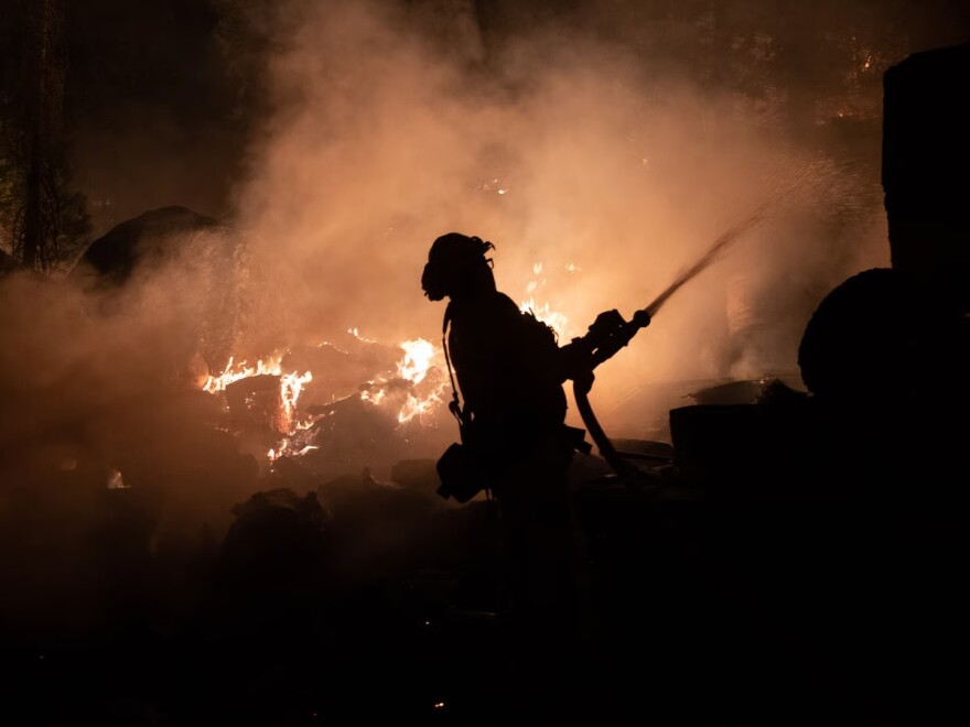 Firefighters protect homes in Christmas Valley from the Caldor Fire Monday, Aug. 30, 2021.