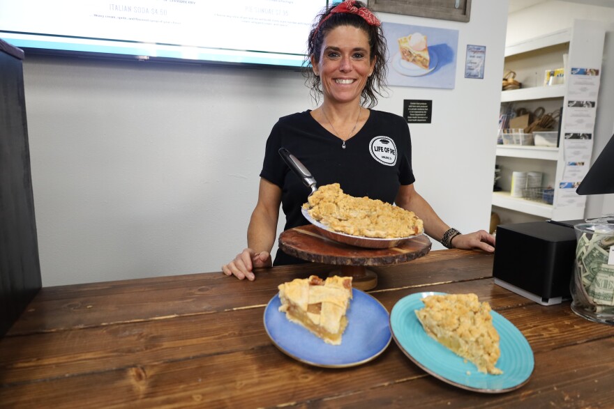 Leslie, co-owner of Life of Pie, with her apple lattice and apple crumble pies. Photo by Allison Diaz.