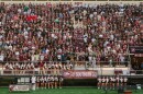 Members of the SIU Carbondale Class of 2029 gather for a class photo in the bleachers at the football field.