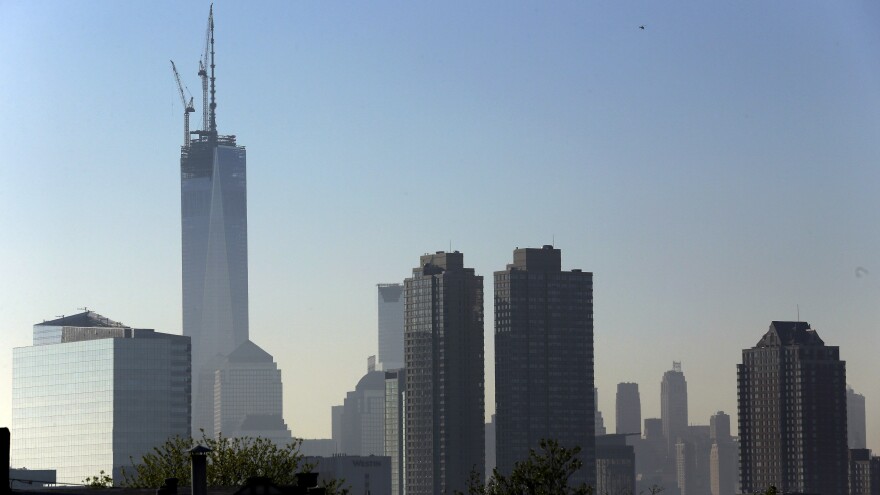 One World Trade Center stands at its full height of 1,776 feet Friday, after a crane lifted its spire into place. The New York City skyline is seen here from the Heights neighborhood of Jersey City, N.J.