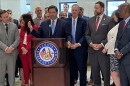 Gov. Ron DeSantis (at podium)