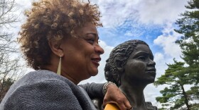 JerriAnne Boggis, executive director of the Black Heritage Trail of New Hampshire, poses with a monument that was erected in Harriet E. Wilson's honor. Boggis says when she read Wilson's book, she felt as if it was written the book just for her.