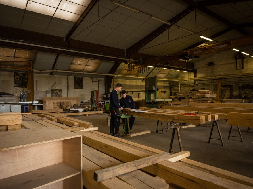 Carpenters at Ateliers Perrault work on trusses in Saint-Laurent-de-la-Plaine, France.