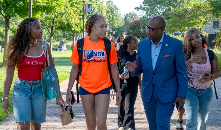 President David K. Wilson walks and talks to students on the first day of class