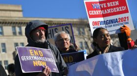 People gather during a rally to coincide with the Supreme Court hearings on the redistricting cases in Maryland and North Carolina, in front of the US Supreme Court in Washington, DC.