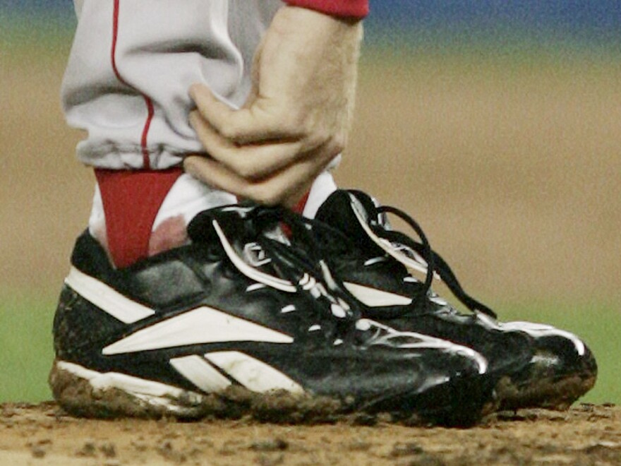 Schilling tends to his right ankle during Game 6 of the American League Championship Series against the New York Yankees in 2004.