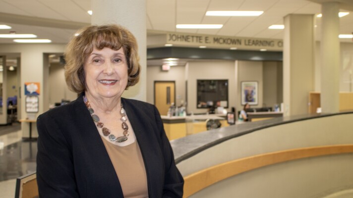 Johnette McKown, president of MCC, poses for a photo in front of the learning commons named in her honor. McKown announced she would retire in May after 17 years as president.