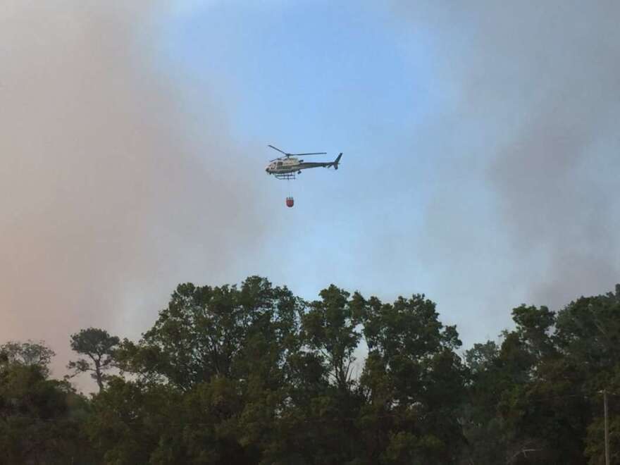 A helicopter dumps water on a fire in the Chuluota area, Seminole County, on April 8th. Photo: Florida Forest Service