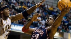 New Jersey Nets forward Rodney Rogers puts up a shot against Indiana Pacers forward Jermaine O'Neal during the first quarter of a basketball game in Indianapolis, April 9, 2004.