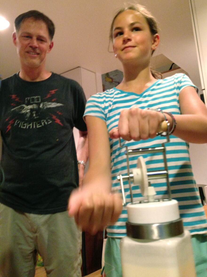 Riley Casagrande churns butter with her dad Jerry Casagrande.