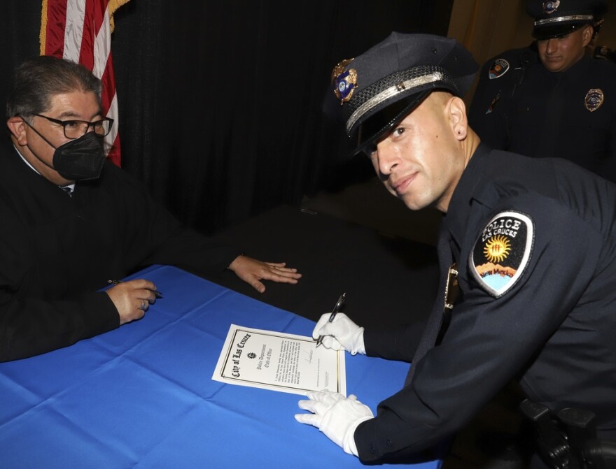 In this photo provided by the City of Las Cruces, New Mexico, Officer Jonah Hernandez signs his oath after graduating from the Las Cruces Police Department’s academy, in June 2022. Hernandez, 35, suffered a fatal stab wound on Sunday, Feb. 11, 2024, when responding to a call about a man who was trespassing on private property. The trespasser was shot and killed by a passerby who watched the attack on the officer. Officials say it was the first on-duty death among officers in the 96-year-old history of the Las Cruces Police Department. (City of Las Cruces, New Mexico via AP)