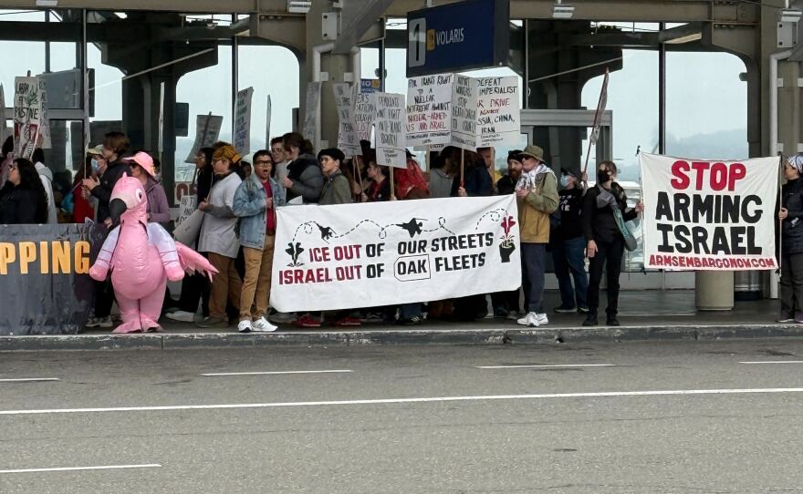 Demonstrators gather at Oakland San Francisco Bay Airport during a May Day rally on Friday, May 1, 2026.