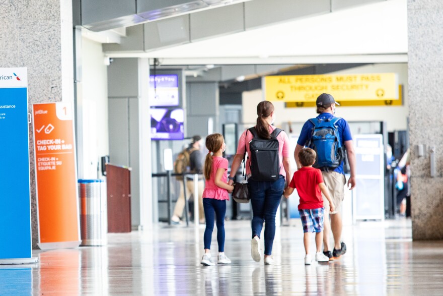 A family walks through the Barbara Jordan Terminal at Austin-Bergstrom International Airport