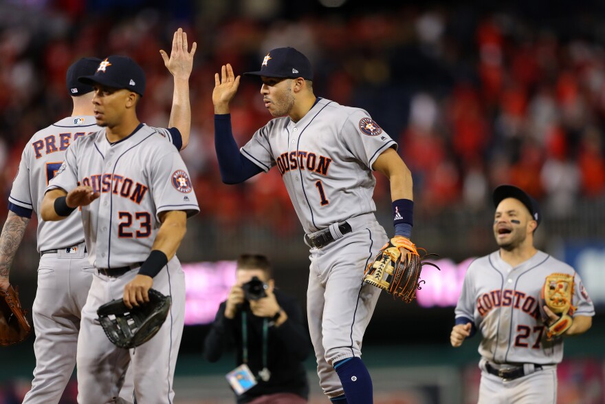 Carlos Correa, #1 of the Houston Astros, celebrates with teammates after the Astros defeated the Washington Nationals in Game 5 of the World Series at Nationals Park on Sunday in Washington, D.C.