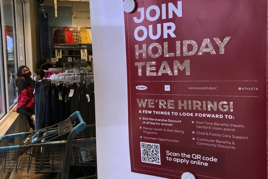 Holiday hiring sign is displayed at a retail store in Vernon Hills, Ill.