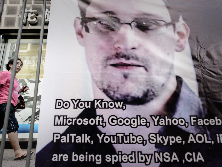 A woman in Hong Kong walks past a banner displayed in support of Edward Snowden this week.