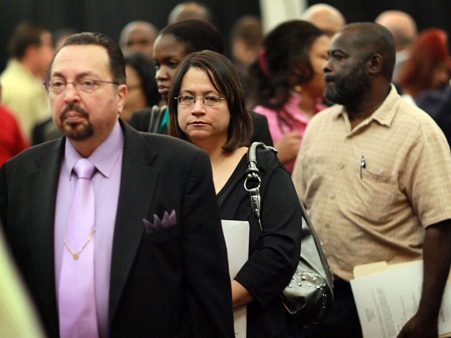 People attend a job fair April 22 in Davie, Fla. The unemployment rate rose to 9.9 percent in April, mainly because 805,000 job-seekers resumed their searches for work.