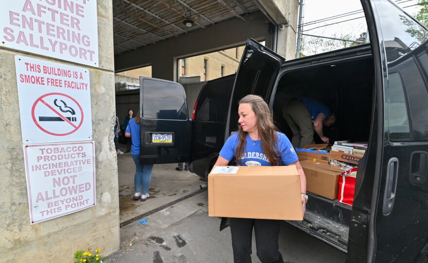 Melissa Janick works to unload books as part of the Leadership Northeast group New Books on the Block at the Luzerne County Correctional Facility.