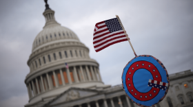 Supporters of former President Trump fly a U.S. flag with a symbol from the group QAnon as they gather outside the U.S. Capitol Jan. 06, 2021 in Washington, D.C. (Win McNamee/Getty Images)