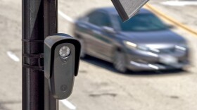 An aerial view of a Flock Safety camera mounted to a light pole on August 03, 2026 in Burbank, California. Flock Safety's automated license plate reader cameras have been deployed in over 120,000 locations across 49 states, using artificial intelligence to identify vehicles by their license plates, make, model and color to help law enforcement investigate crimes, while also drawing criticism from privacy advocates over concerns about mass surveillance and the collection of motorists' location data.