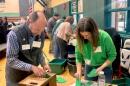 Ken Traum and Andrea Kane count the ballots cast for Hopkinton’s school district’s operating budget.