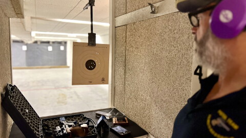Carl Simons, a member of the Falmouth Rod & Gun Club, reviews a target at the club's indoor shooting range.