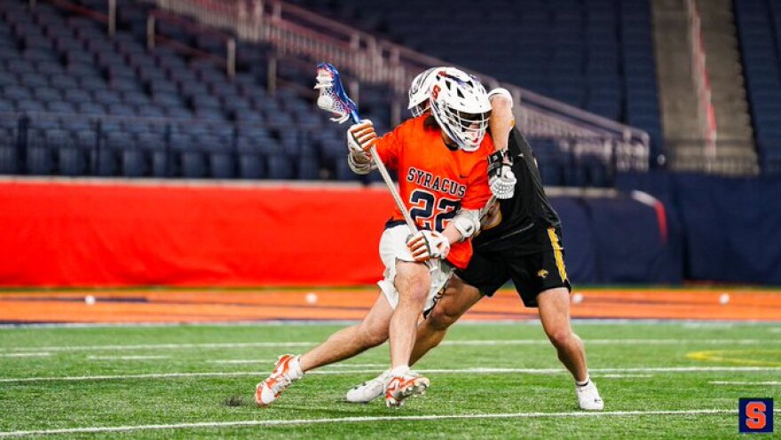 SU attackman Joey Spallina (22, Orange) works around a defender in SU’s 18-7 win over No. 17 Towson.
