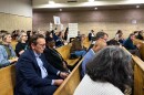 Utility Commissioner Donald van der Vaart interrupted the hearing to ask audience members to lower their anti–data center signs.