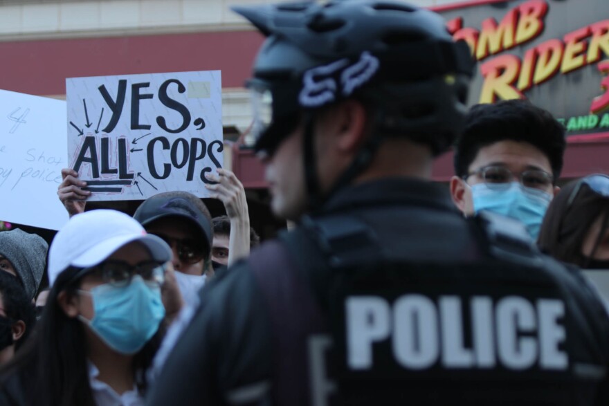 Demonstrators face a line of San Antonio officers at a protest against police brutality at Alamo Plaza on May 30, 2020. The protest occurred days after Minneapolis police officers killed George Floyd.