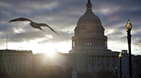 At dawn, the sun breaks through dark clouds over Capitol Hill in Washington, Thursday, March 7, 2013.