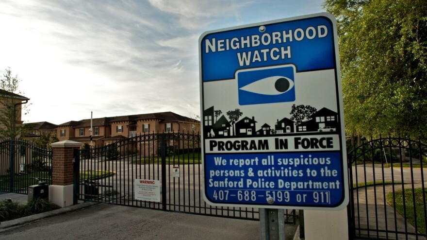 A neighborhood watch sign stands outside The Retreat at Twin Lakes, the gated community in Sanford, Fla., where Trayvon Martin was shot by George Zimmerman on Feb. 26. 