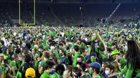 Fans storm the field after Notre Dame defeated the Clemson 47-40 in two overtimes in an NCAA college football game Saturday, Nov. 7, 2020, in South Bend, Ind.