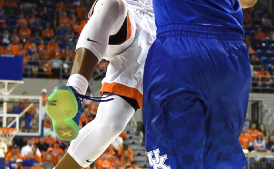 Florida’s Kasey Hill (0) goes up strong against Kentucky’s Jamal Murray (23), drawing a foul in the process midway through the second half. (Greenberry Taylor/WUFT News)