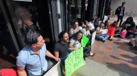 Protesters block the entrance to Miami-Dade County Hall following the January 2017 decision from Mayor Carlos Gimenez to start honoring ICE detainer requests.