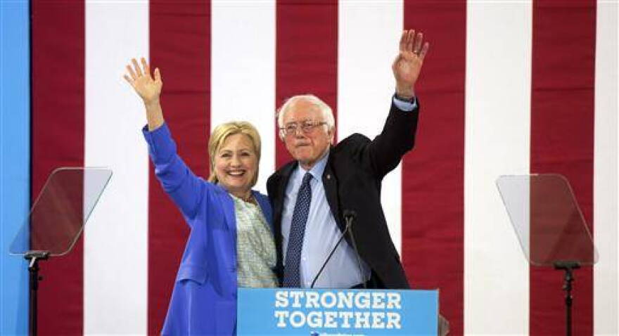 Democratic presidential candidate Hillary Clinton and Sen. Bernie Sanders, I-Vt., wave during a rally in Portsmouth, N.H., Tuesday, July 12, 2016, where Sanders endorsed her for president..