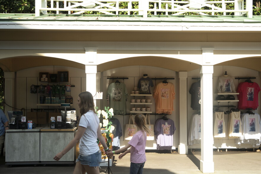 Visitors pass by a merchandise stand at Dollywood on August 26, 2026