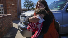 Jennifer Sanchez wipes the face of her 1-year-old son Saul Escamilla after a vaccine at the Ector County Health Department, Monday, Feb. 24, 2025, in Odessa, Texas. (AP Photo/Julio Cortez)